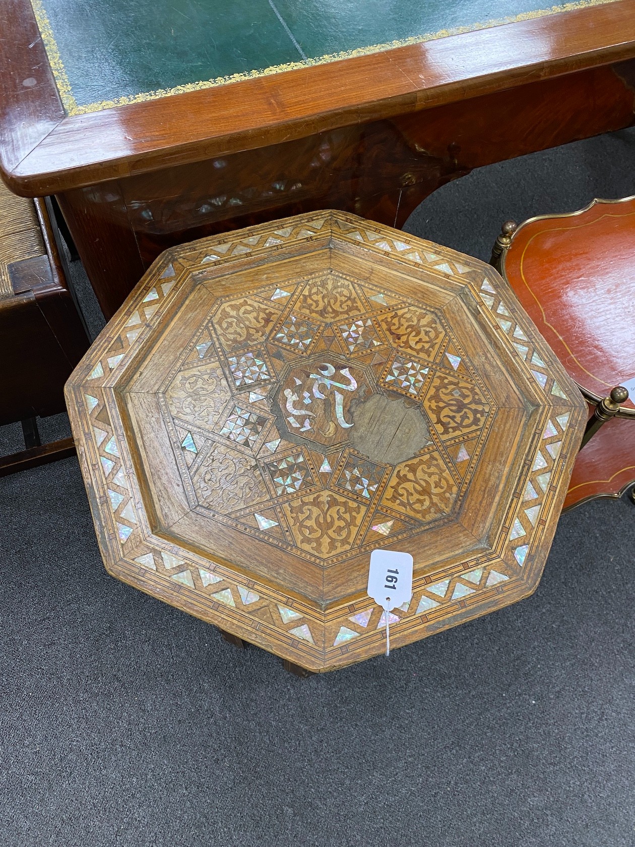 A Moorish octagonal mother of pearl inlaid table width 48cm, height 62cm.